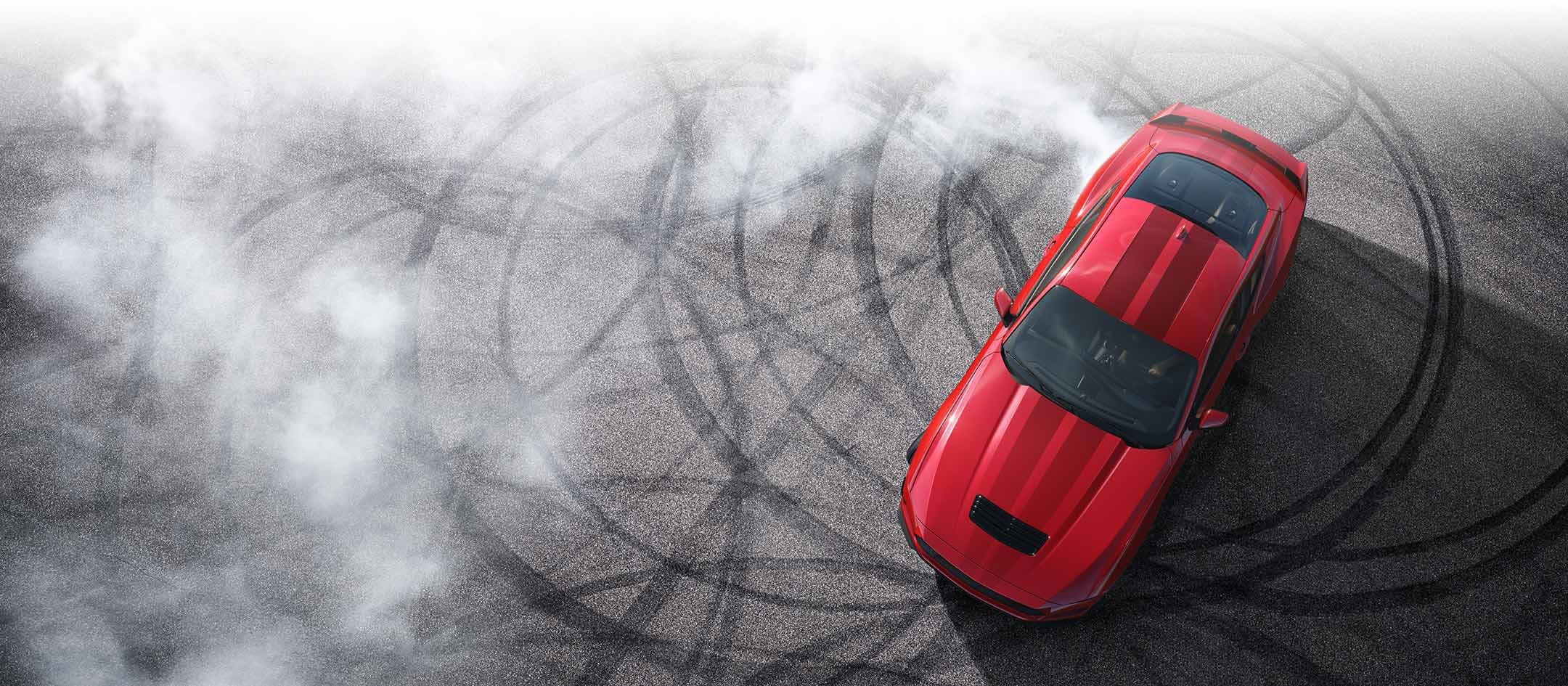 Overhead view of a 2024 Ford Mustang® model with tire tracks on pavement | Sam Scism Ford in Farmington MO
