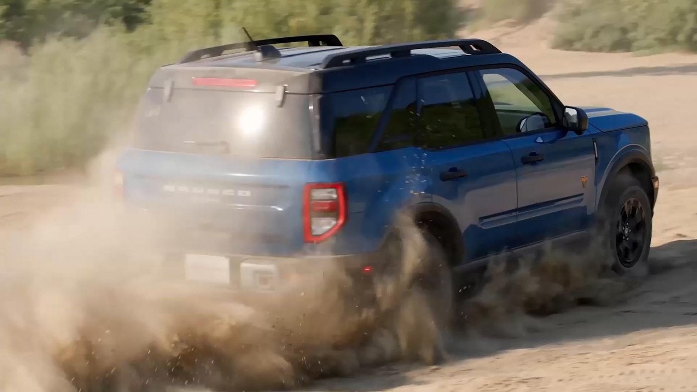 Blue Ford Bronco Sport kicking up dust on a sandy dirt trail, Farmington MO