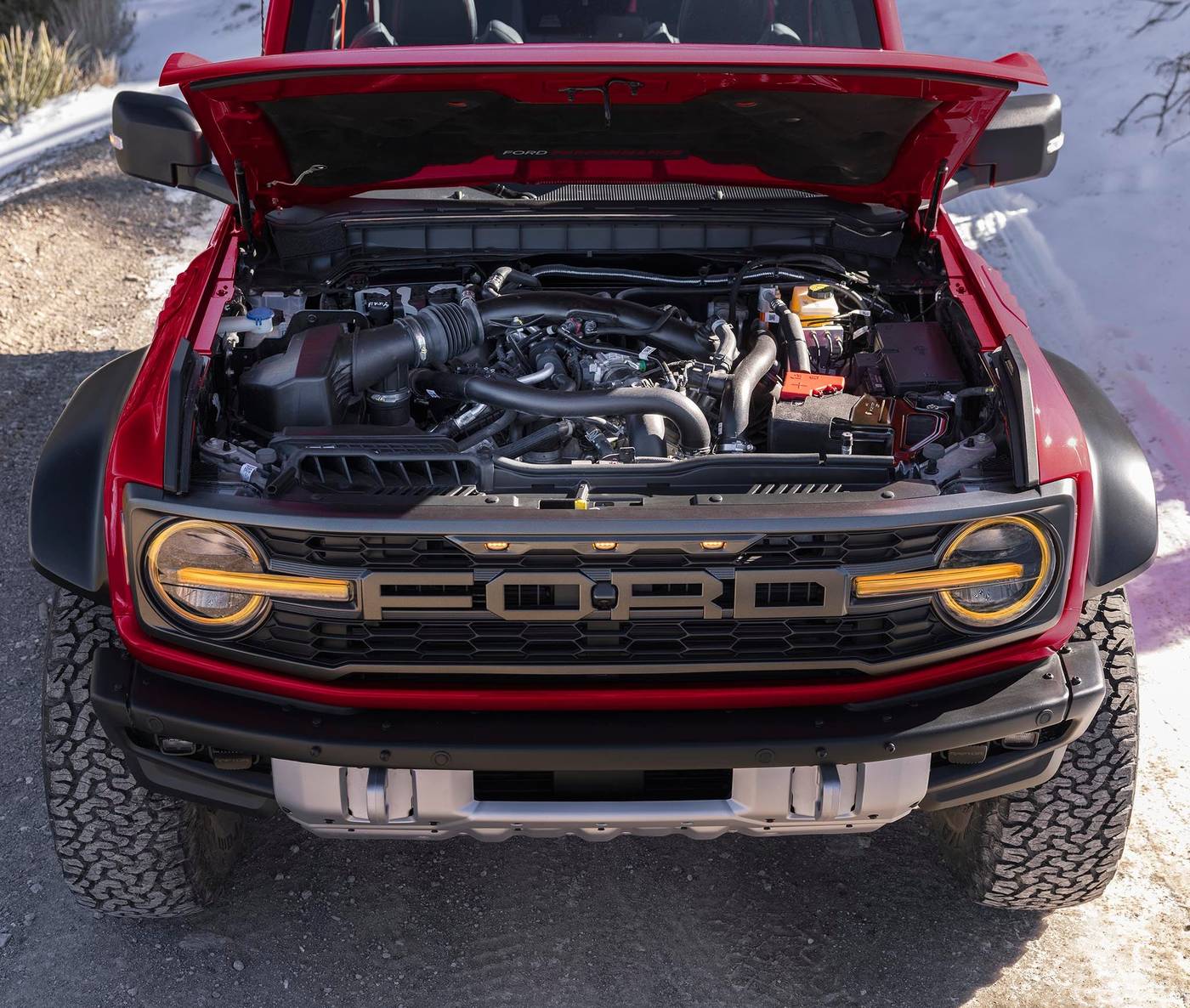 Red Ford Bronco Raptor with the hood up showing the engine bay, ready for a battery check in Farmington MO