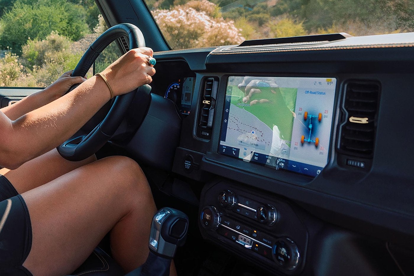 Driver with a Ford Bronco touchscreen showing off road vehicle status, Farmington MO
