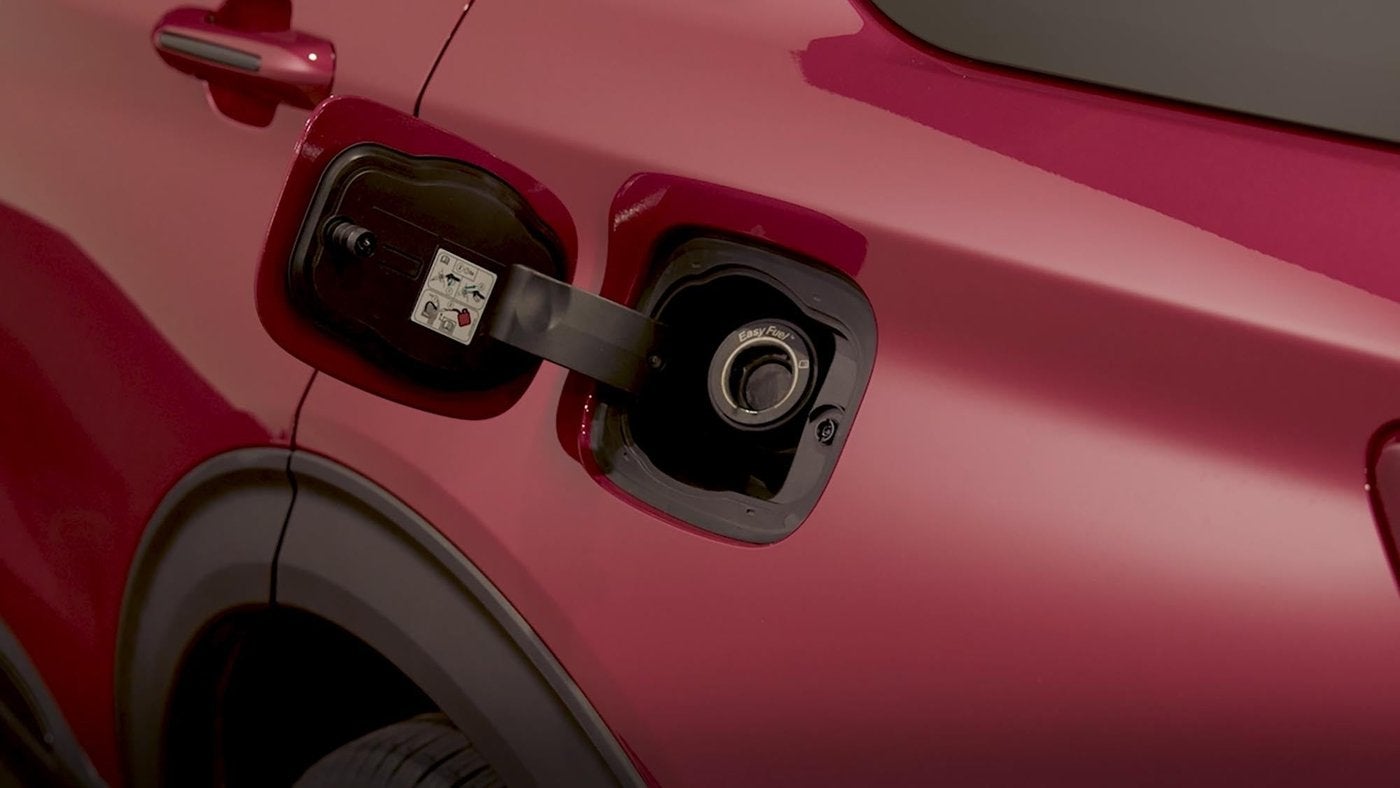 Open capless fuel filler door on a red Ford, where good fueling habits start for diesel owners in Farmington MO