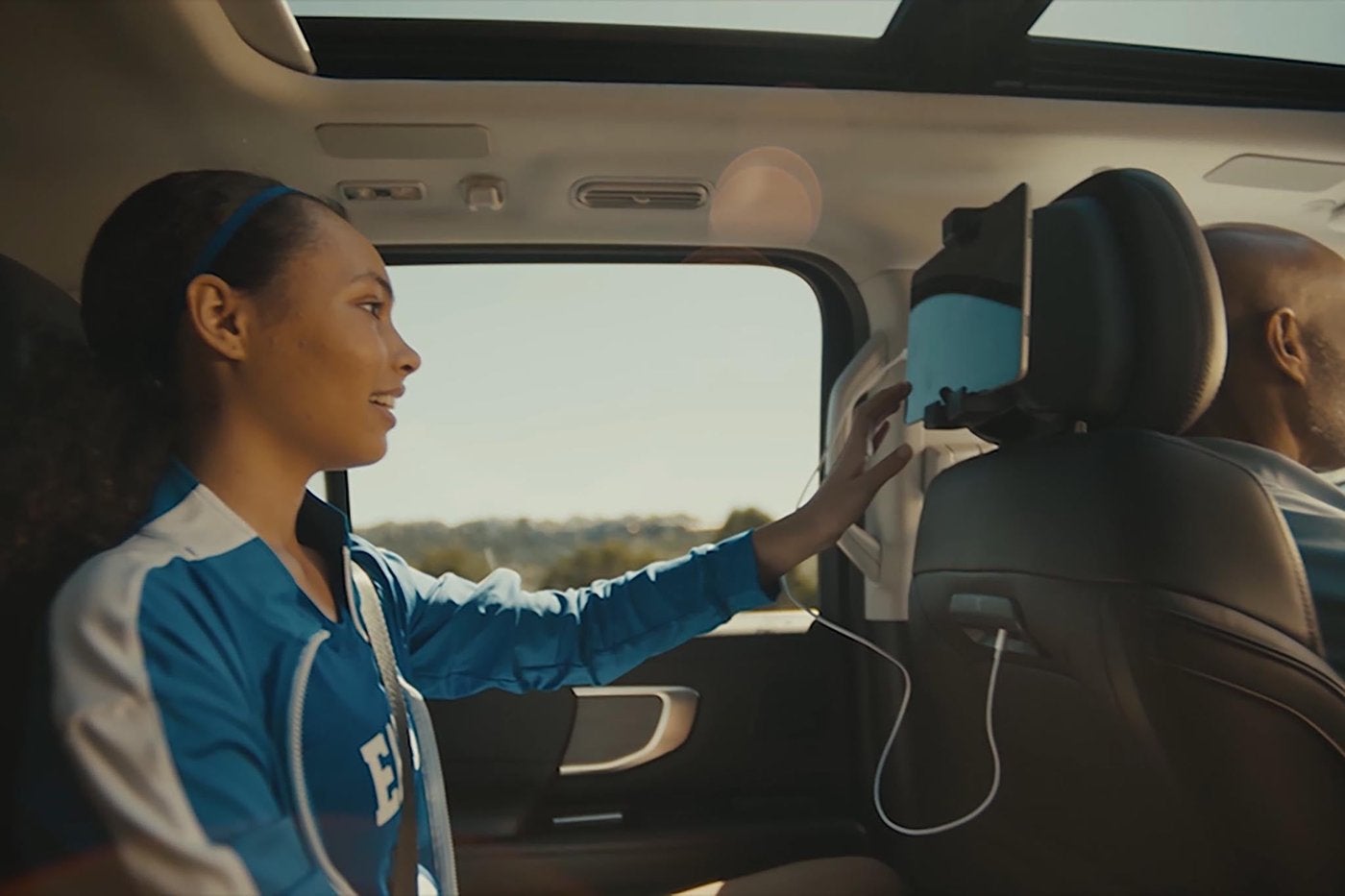 Girl in the second row of a Ford Expedition using a seatback device holder Girl in the second row of a Ford Expedition using a seatback device holder, Farmington MO