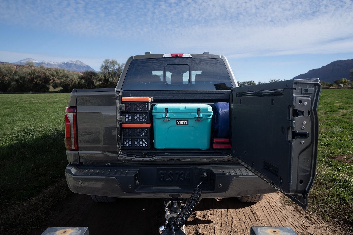 Ford F-150 Pro Access Tailgate swung open with a cooler and crates in the bed, Farmington MO