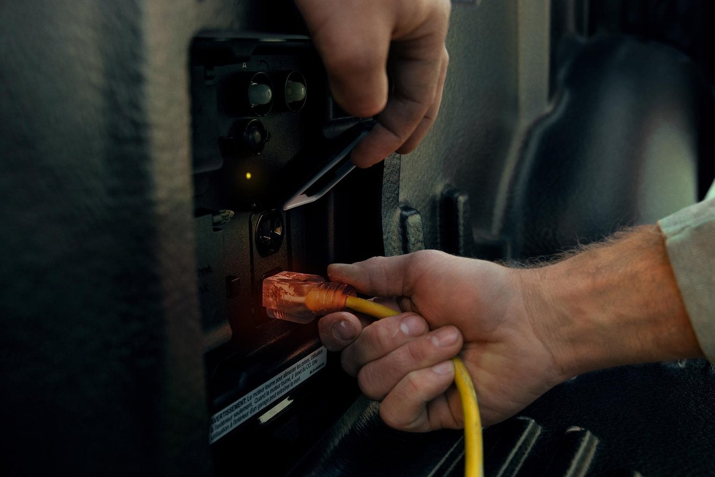Hand plugging a cord into Ford F-150 Pro Power Onboard outlets Hand plugging a cord into Ford F-150 Pro Power Onboard outlets, job site power in Farmington MO