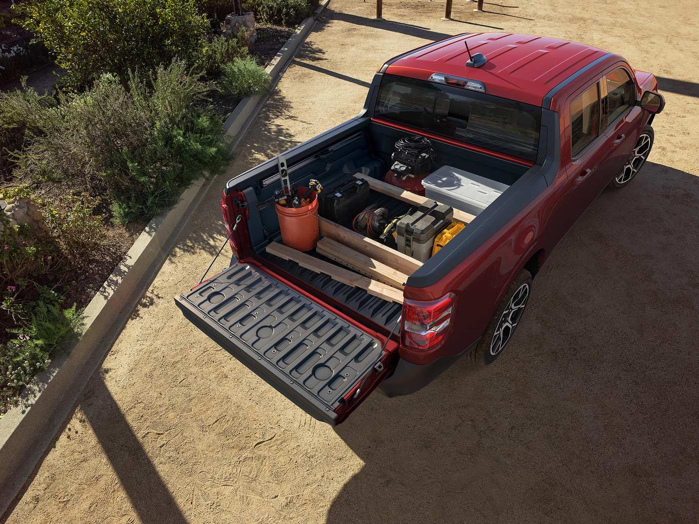 Overhead view of a red Ford Maverick FLEXBED loaded with lumber Overhead view of a red Ford Maverick FLEXBED loaded with lumber, tools and buckets, tailgate down, Farmington MO