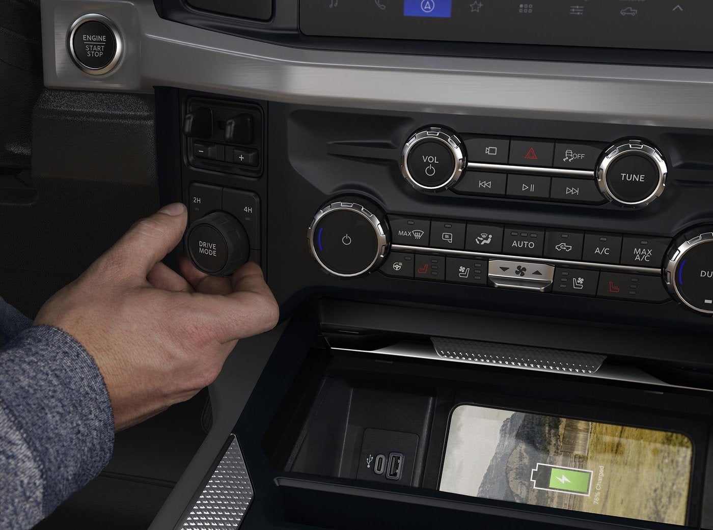 Hand turning a Ford Super Duty drive mode knob beside the climate controls Hand turning a Ford Super Duty drive mode knob beside the climate controls, four wheel drive check in Farmington MO