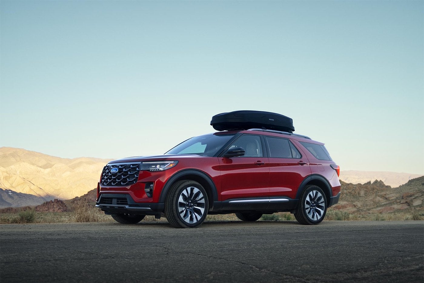 Red Ford Explorer with a roof box parked beside a desert road, a late model SUV to shop in Farmington MO