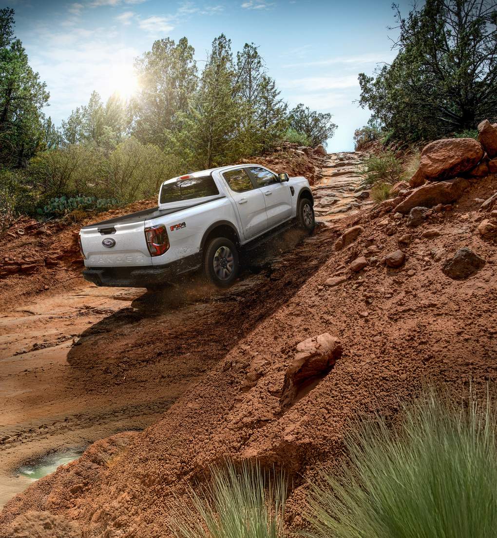 White Ford Ranger Lariat FX4 climbing a steep red dirt trail, Farmington MO