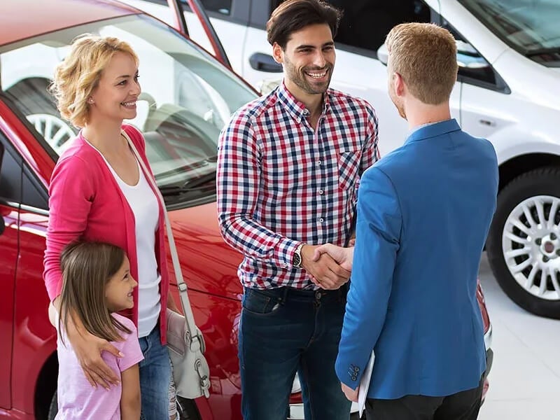 Couple going over options with a sales representative - Sam Scism Ford in Farmington MO